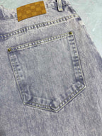 Light-wash Louis Vuitton denim pants with front right pocket and gold-tone rivets