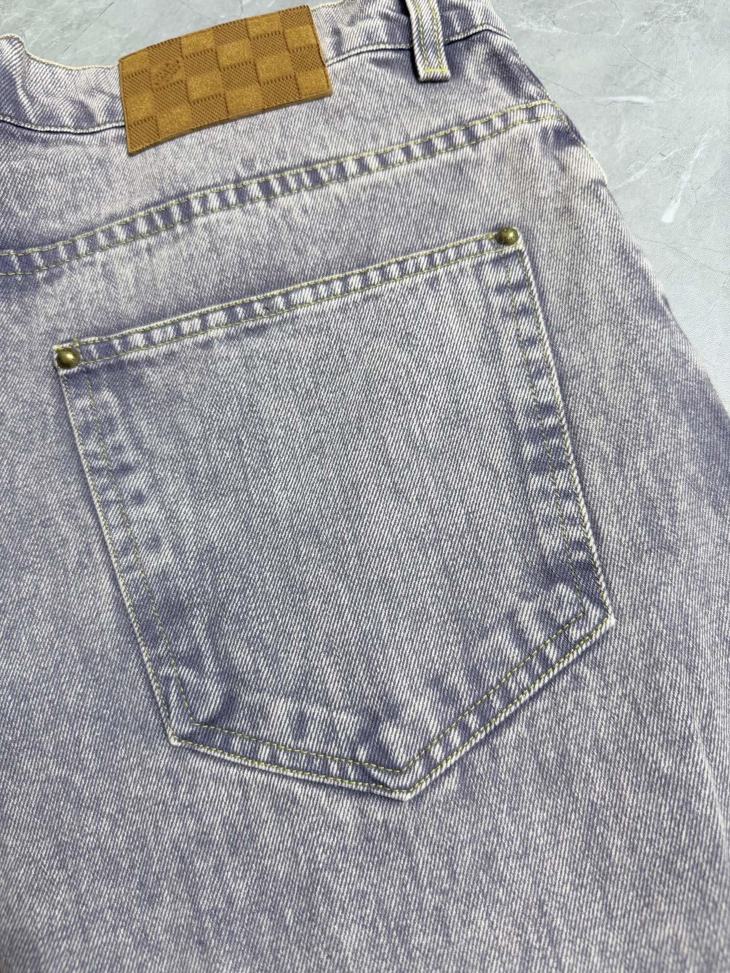 Light-wash Louis Vuitton denim pants with front right pocket and gold-tone rivets