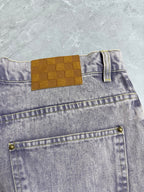 Light-wash Louis Vuitton denim pants with check-style patch and front coin pocket