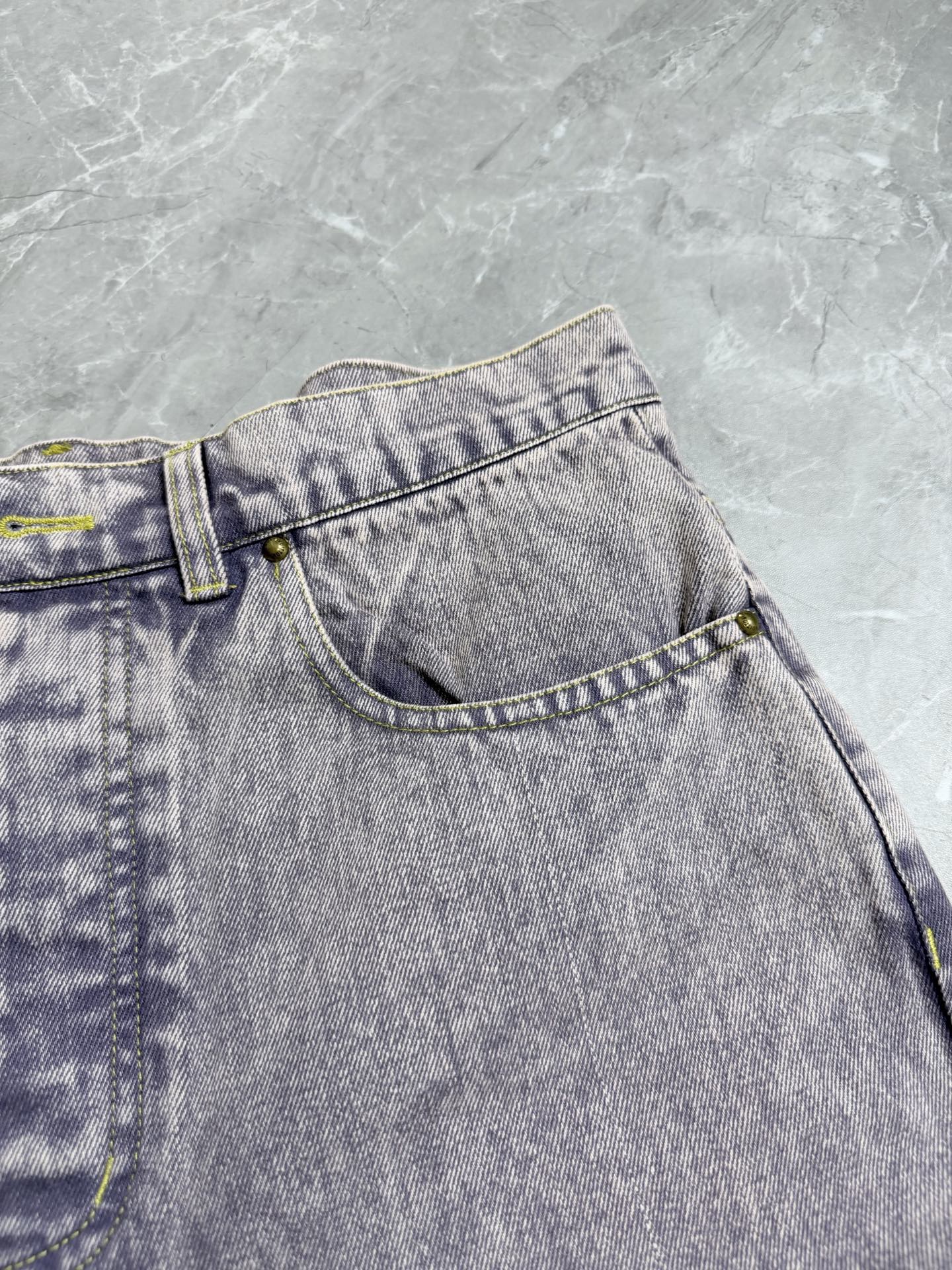 Light-wash Louis Vuitton denim waistband detail with belt loops and button
