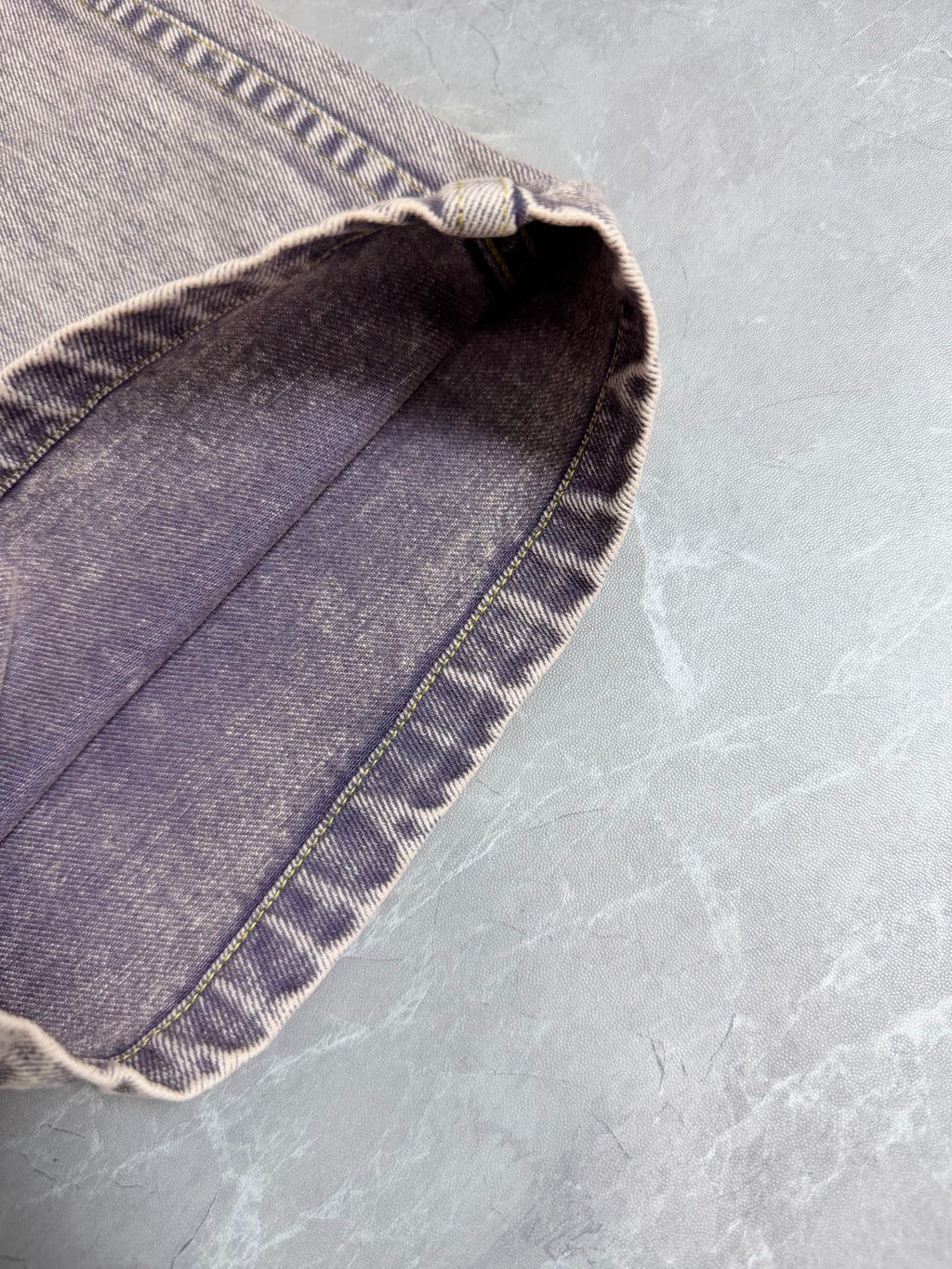 Light-wash Louis Vuitton denim pants folded hem detail with contrast stitching