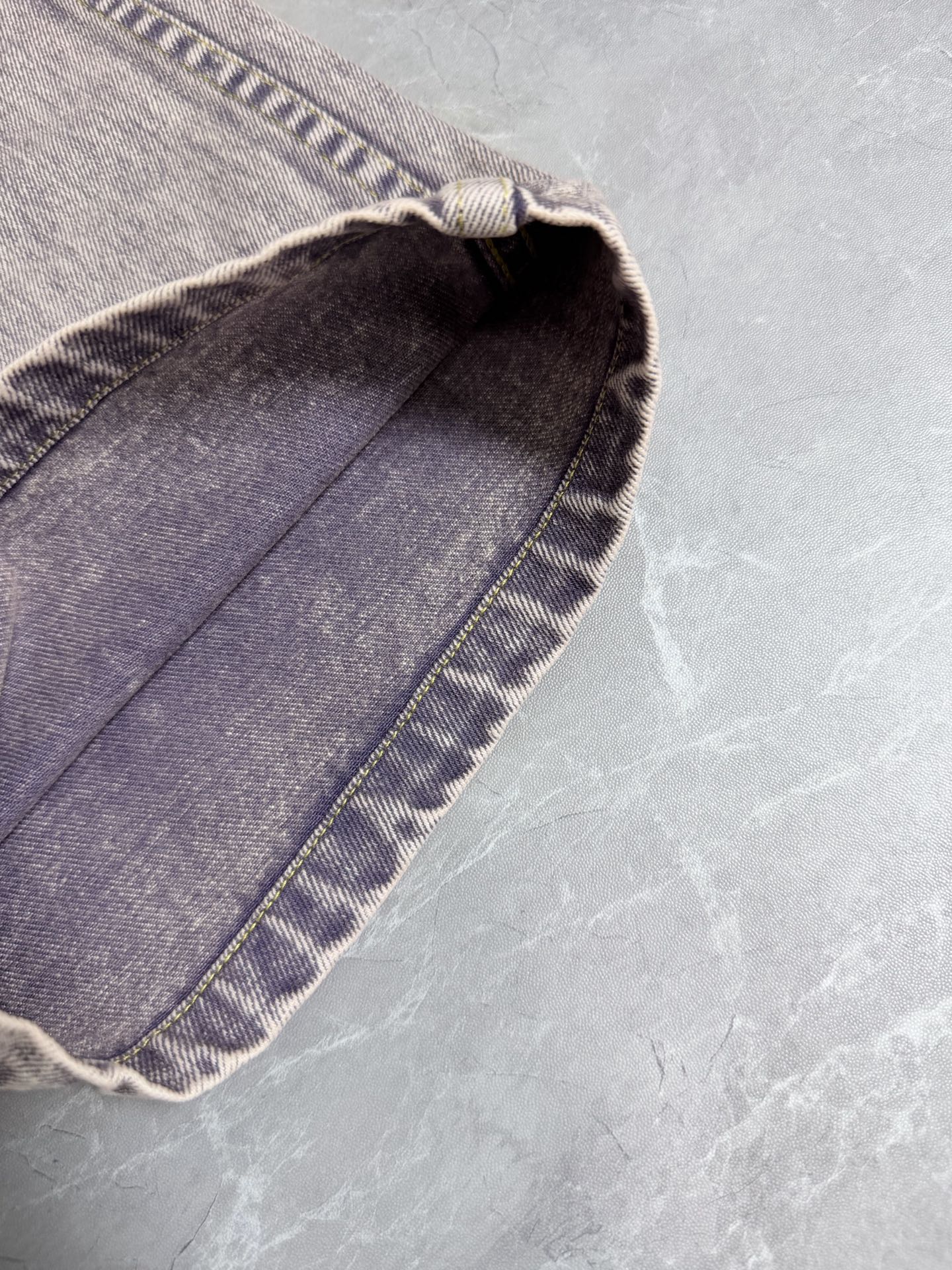 Light-wash Louis Vuitton denim pants folded hem detail with contrast stitching