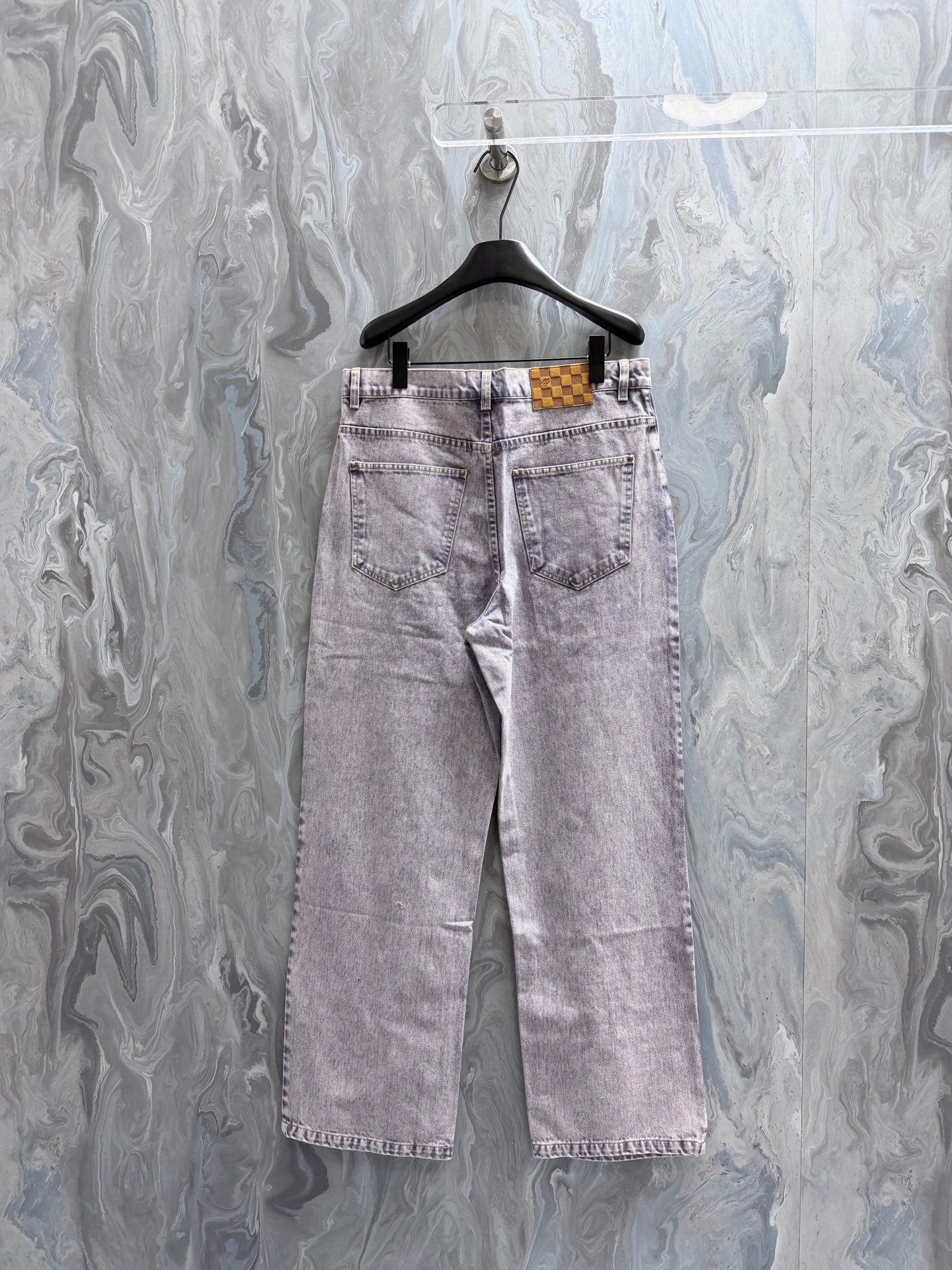 Light-wash Louis Vuitton denim pants with belt loops and rear patch details