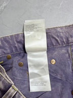 Denim pants waistband care label listing cotton and leather, with gold buttons