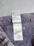 Denim pants waistband with white care label tag and gold button details