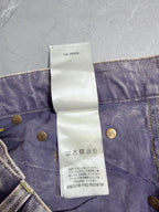Denim pants waistband with care symbol icons on white tag and gold button
