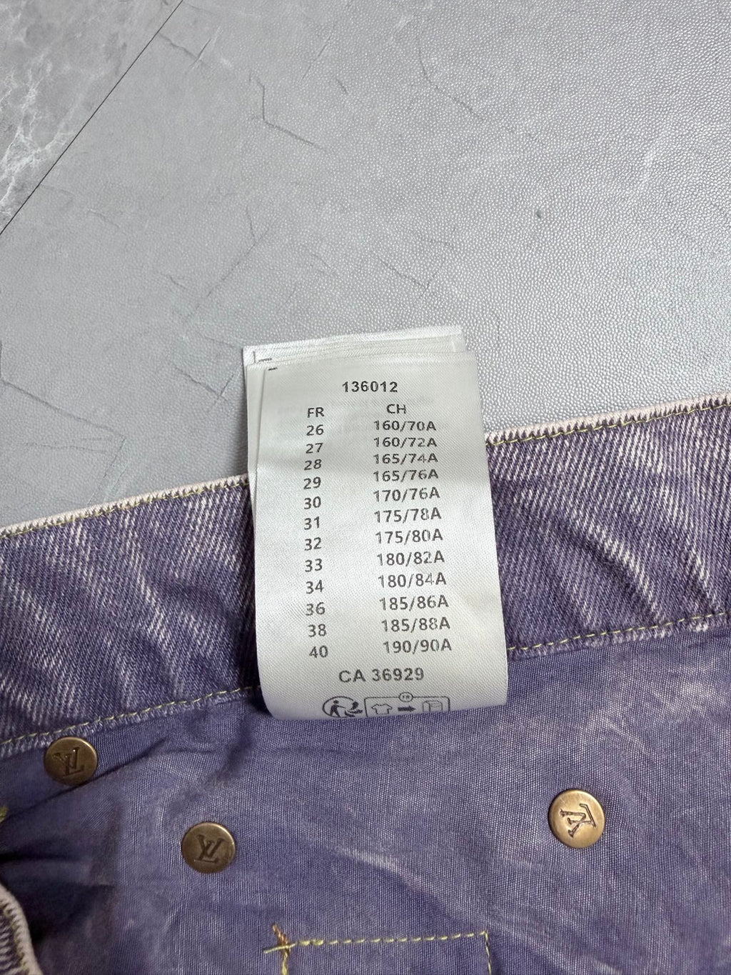 Denim pants waistband size code label with measurement list and gold button