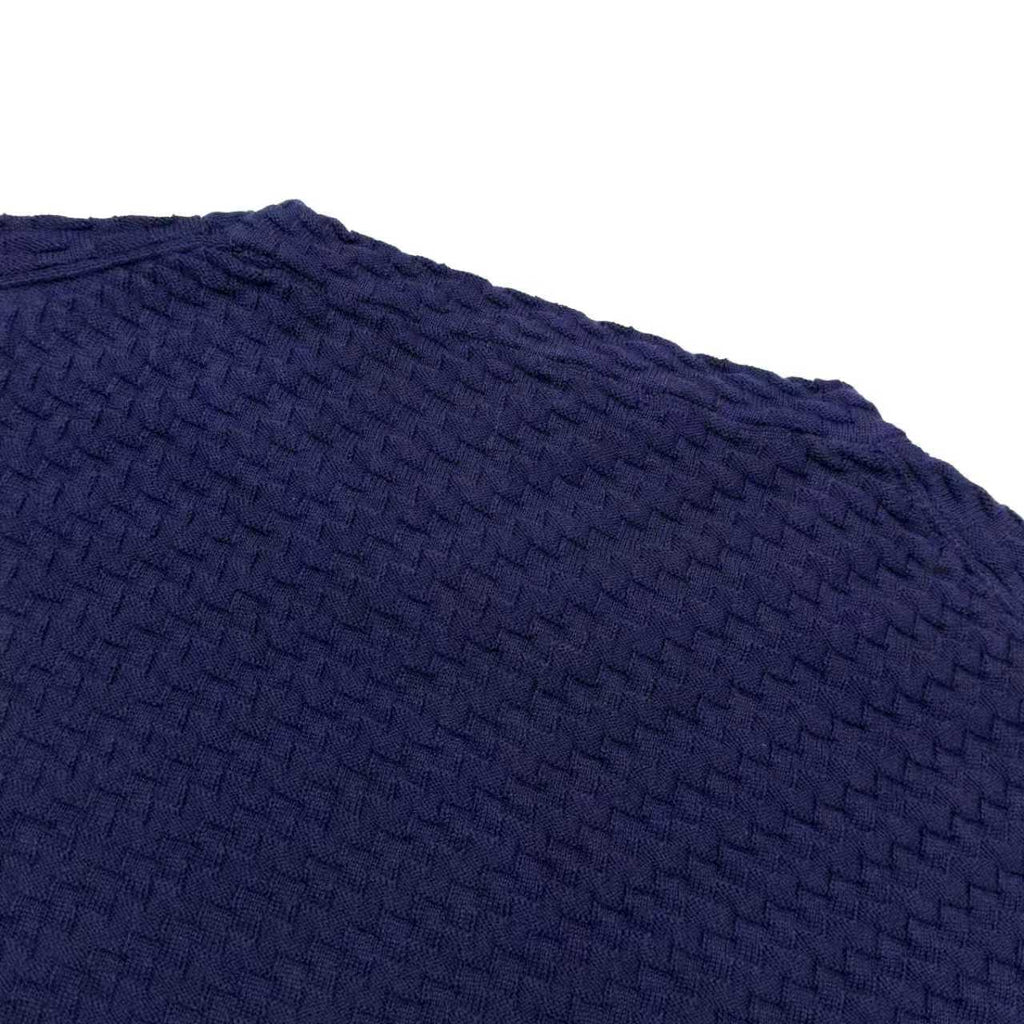 Dark blue short-sleeve knit sweater close-up of textured stitch pattern