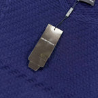 Dark blue textured knit sweater with neck tag and fabric weave detail