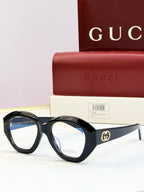 Black round sunglasses with clear lenses and gold double-G logo on temples
