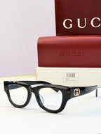 Gucci optical glasses with black acetate frames and clear lenses, gold logo at temple