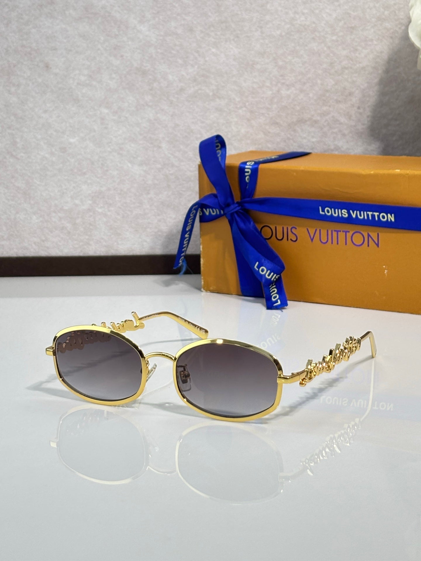 Louis Vuitton sunglasses with gold-tone round frames and dark gradient lenses