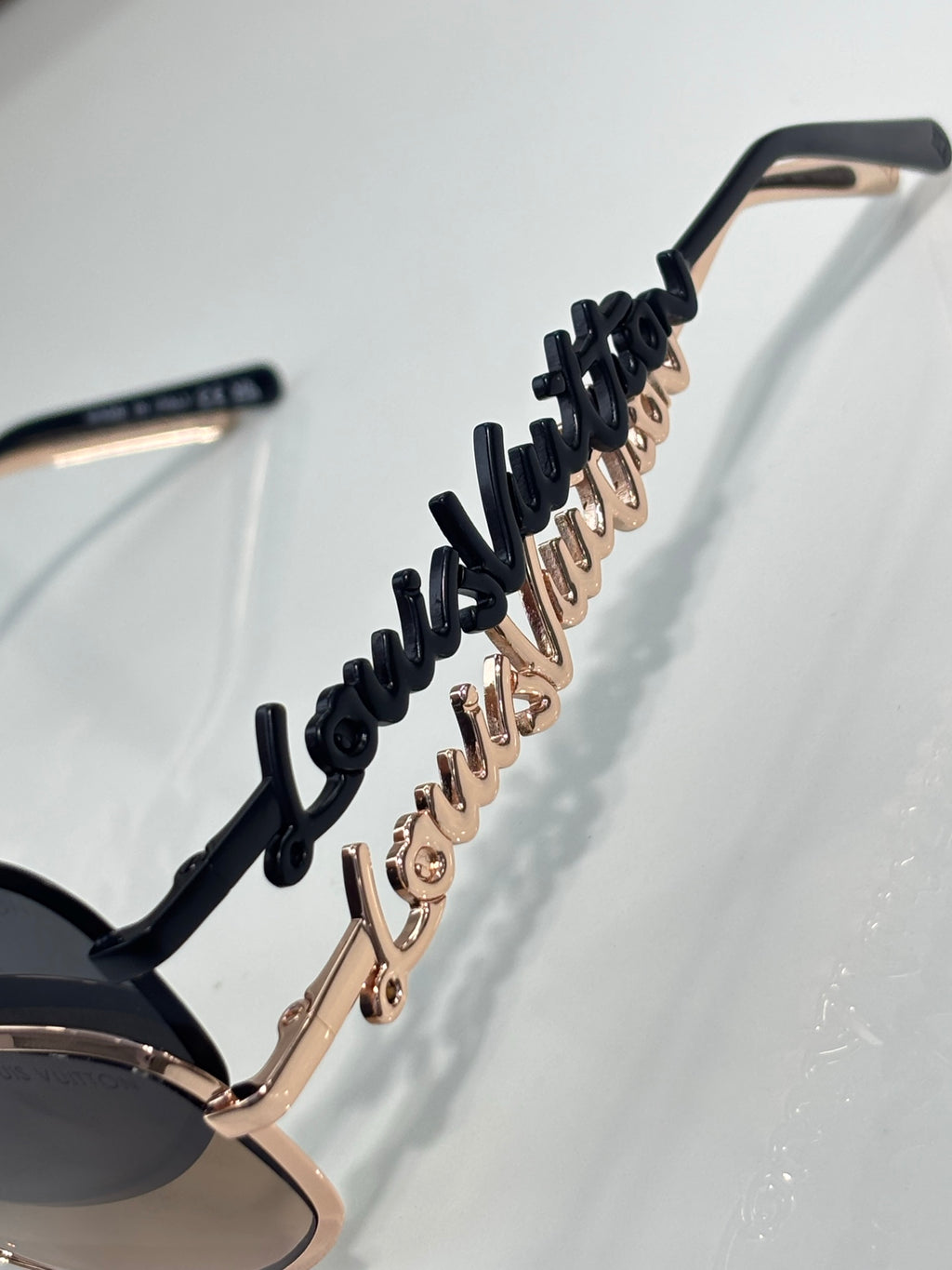 Louis Vuitton sunglasses side temple with black detailing and rose gold accents