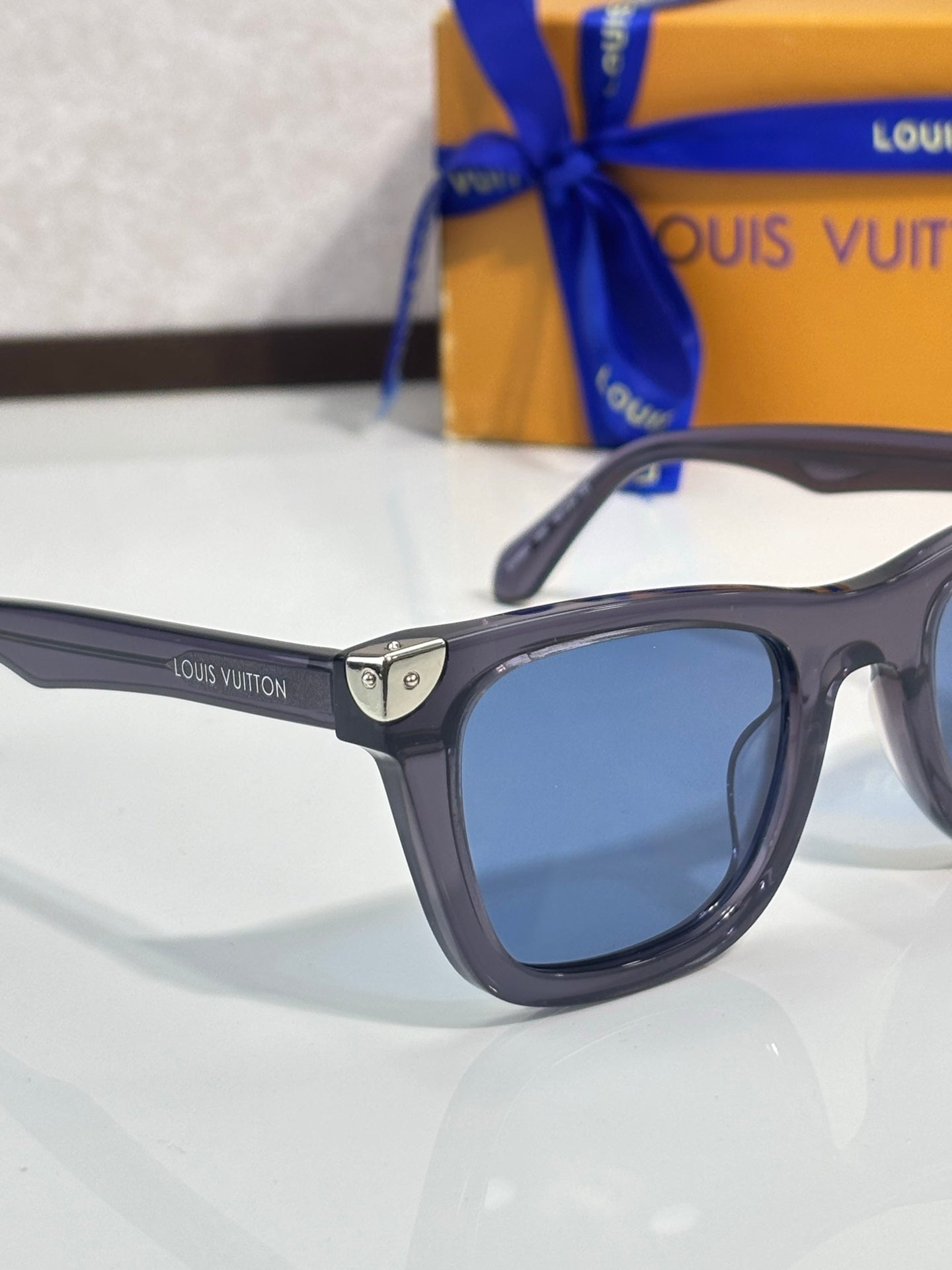 Louis Vuitton glasses, dark frame with blue-tinted lenses