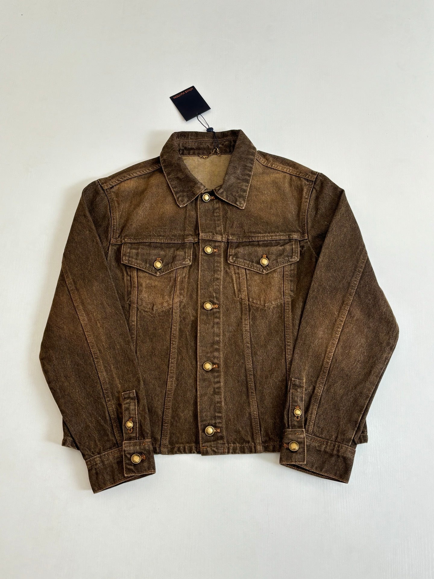 Louis Vuitton brown denim jacket front view with snap button placket and flap pockets