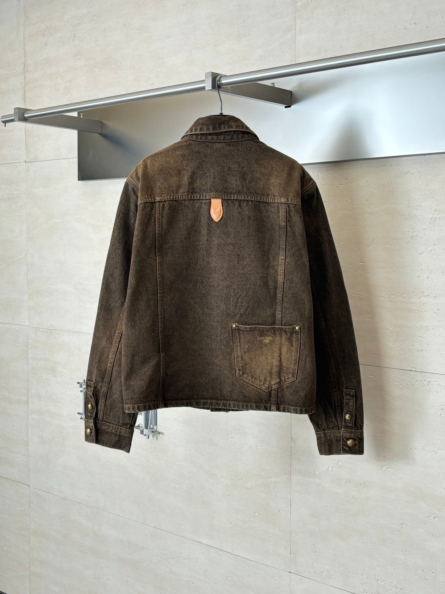 Louis Vuitton brown denim jacket back view with central seam and button details