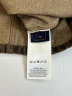 Louis Vuitton long clothing care label on dark brown fabric