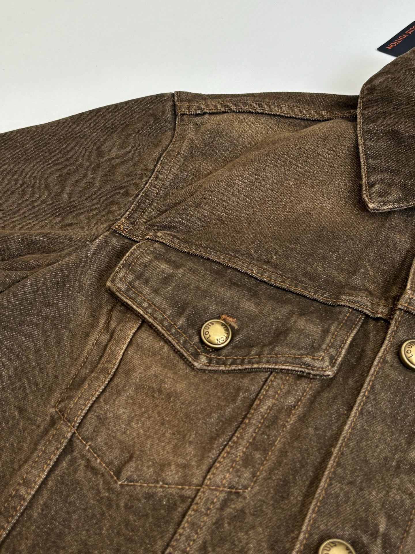Louis Vuitton brown denim jacket close-up of shoulder yoke and flap chest pocket