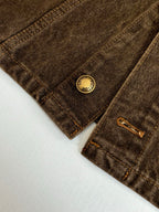 Louis Vuitton denim jacket close-up of pocket with gold LV-style button