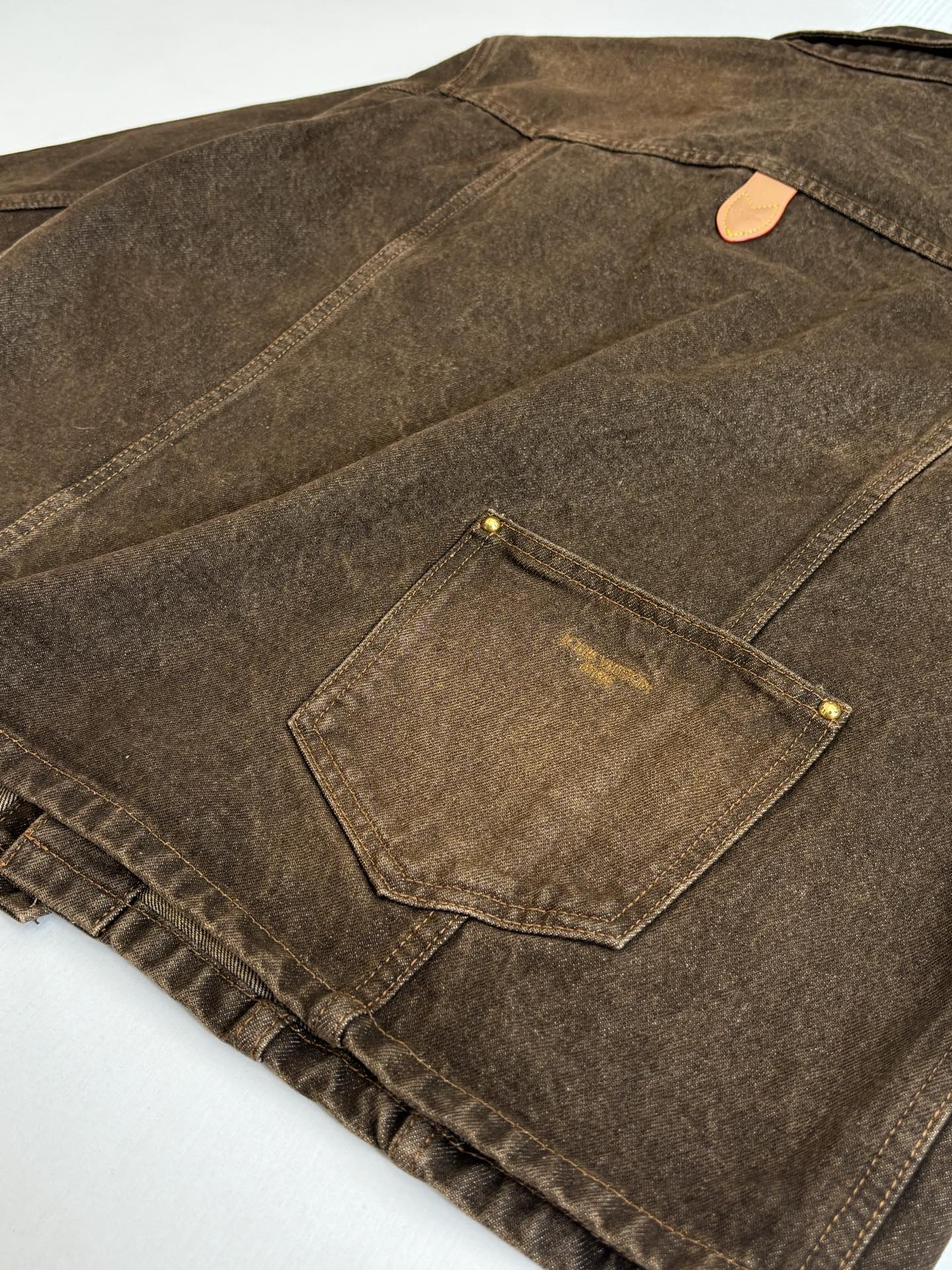 Louis Vuitton brown denim jacket close-up of back panel seam and pocket