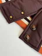 Louis Vuitton long bomber jacket cuff and button detail, orange-striped rib and snaps