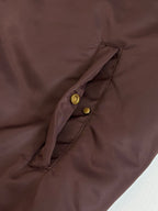 Louis Vuitton long bomber jacket front placket detail with snap buttons on dark brown