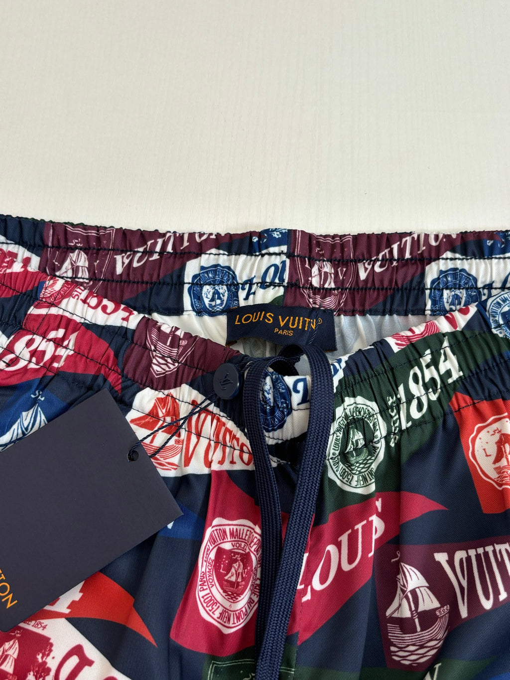 Louis Vuitton logo-print shorts waistband close-up with elastic hem and drawstring