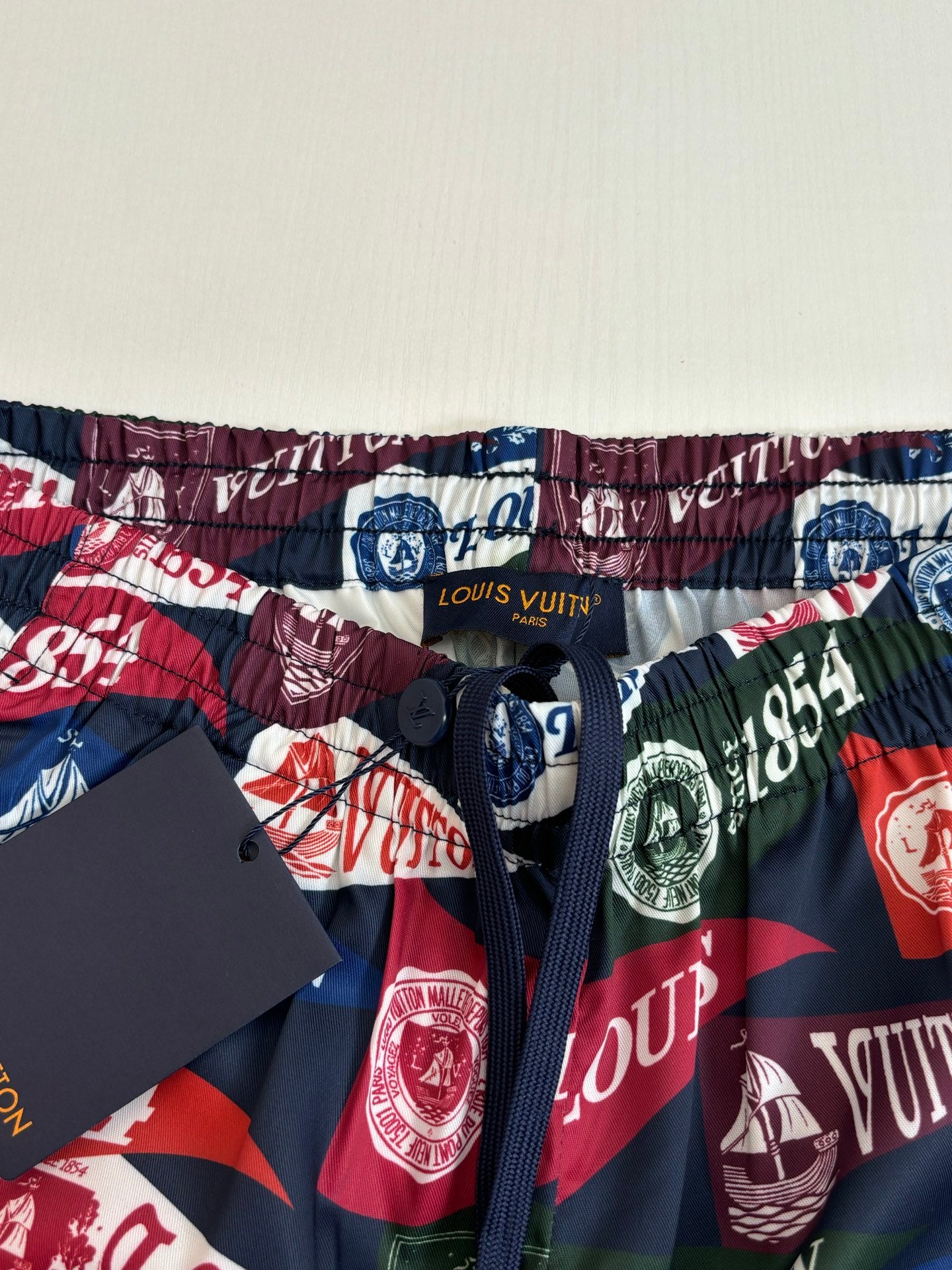 Louis Vuitton logo-print shorts waistband close-up with elastic hem and drawstring
