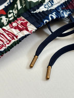 Louis Vuitton drawstring cords with brown tips on logo-print shorts