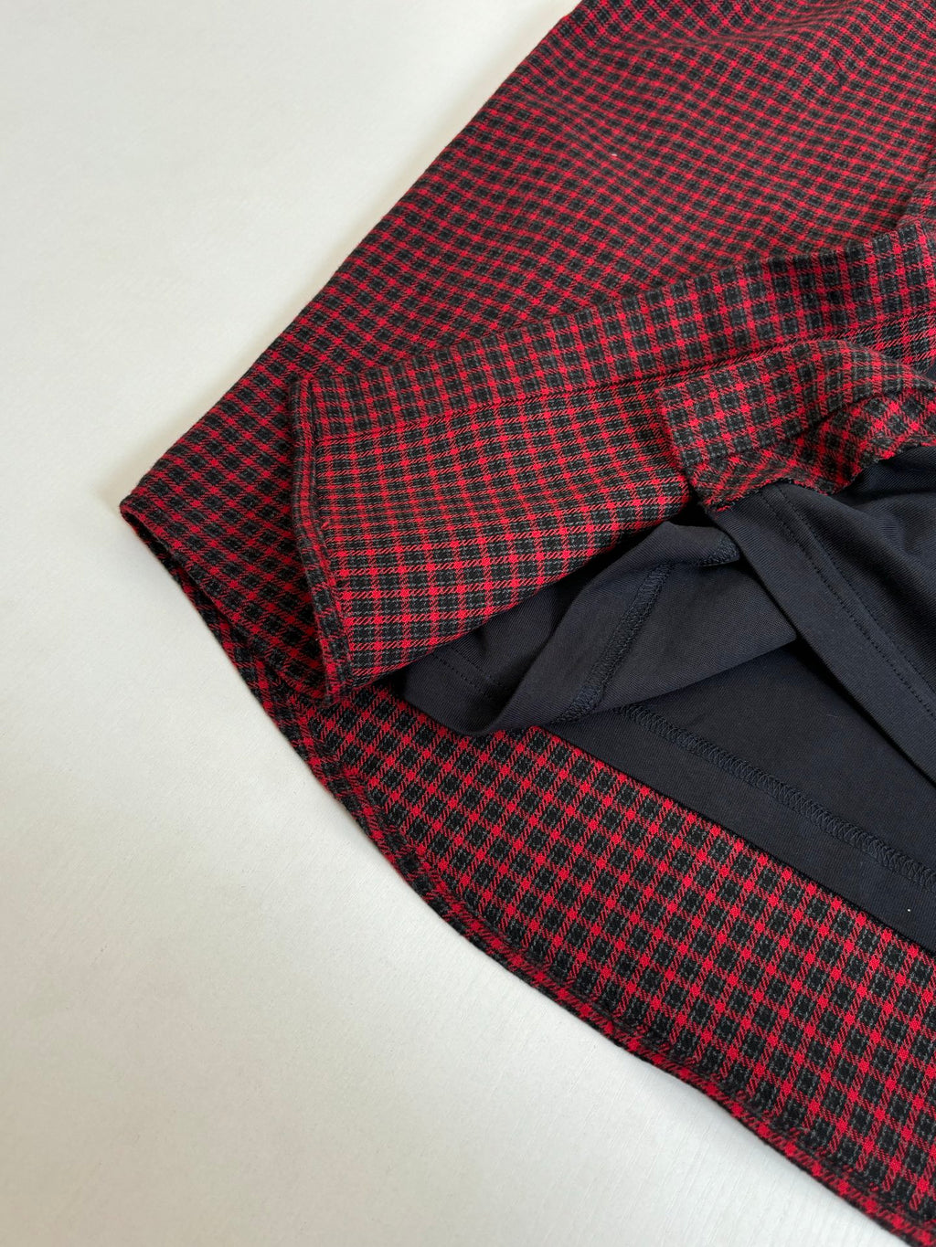 Balenciaga long-sleeve shirt sleeve detail; red check fabric over black wrap section
