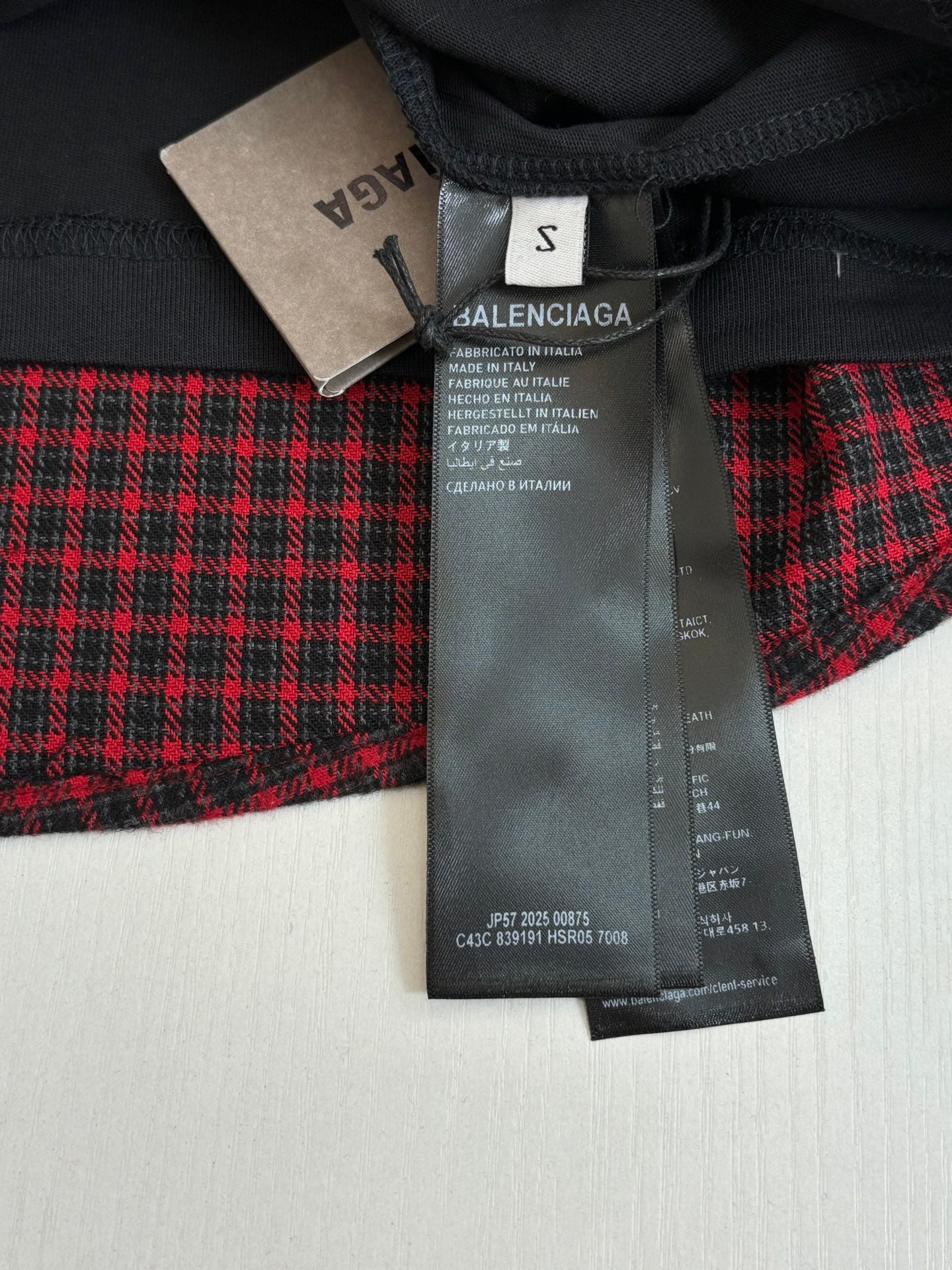 Balenciaga long plaid coat in red and black with attached size tag