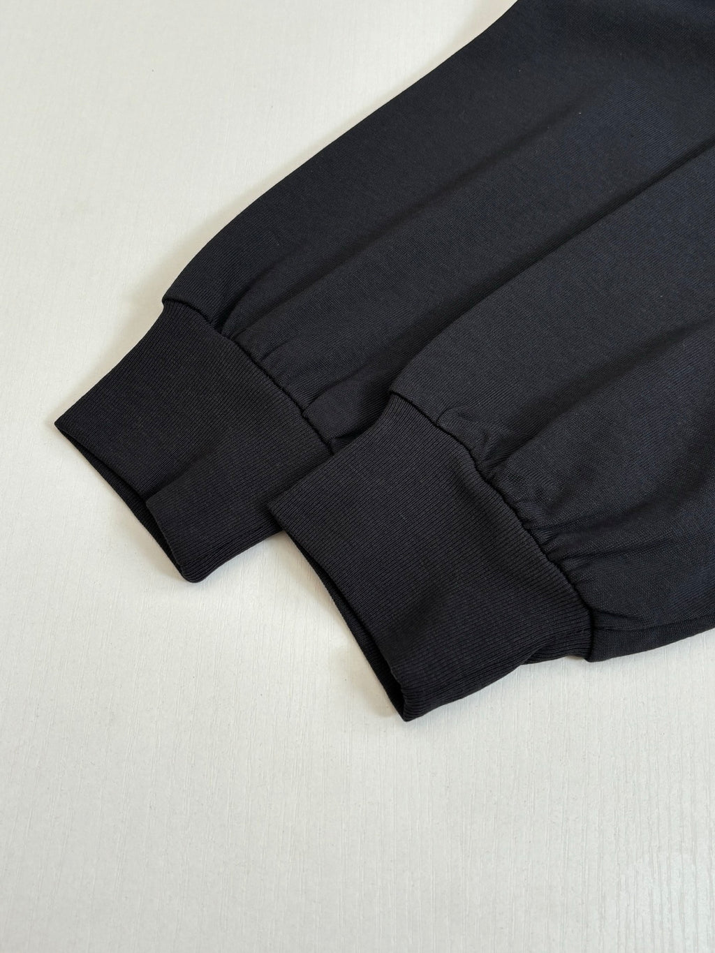Balenciaga long-sleeve shirt cuff and hem detail in black knit