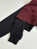 Balenciaga long-sleeve shirt cuff detail; black sleeve with red check shoulder