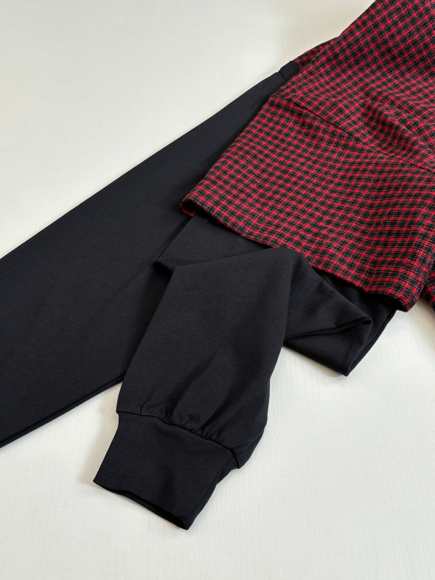 Balenciaga long-sleeve shirt cuff detail; black sleeve with red check shoulder