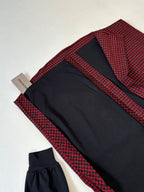 Balenciaga long-sleeve shirt folded flat; red check fabric with black sleeves and cuffs