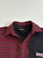 Balenciaga long-sleeve shirt collar closeup; red-and-black check with black placket
