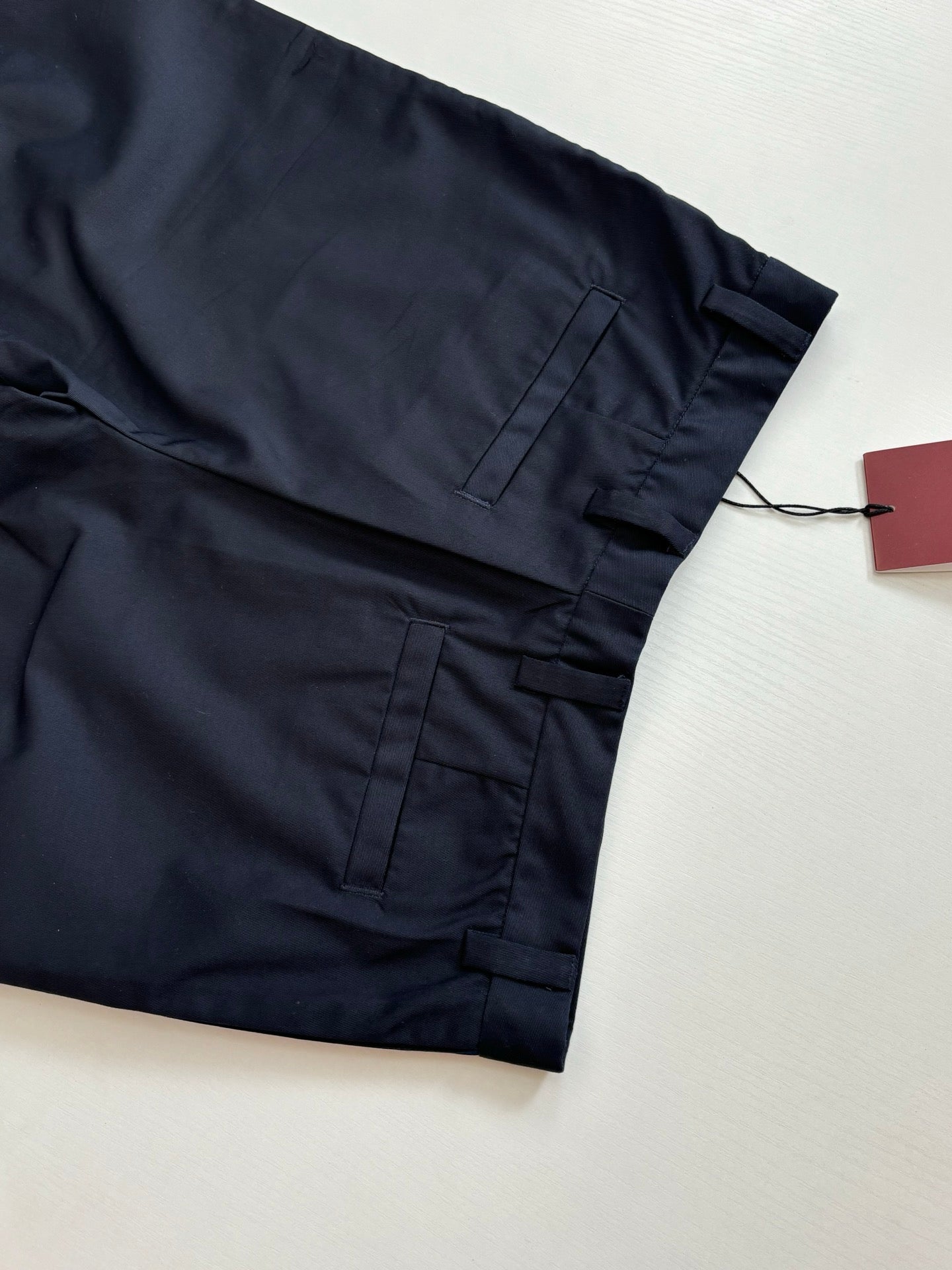 Gucci navy pants pocket and cuff area with belt loops and hanging tag