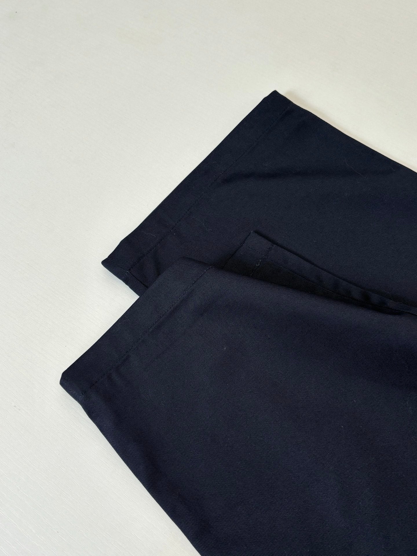 Gucci navy pants folded back view with waistband and seam detail