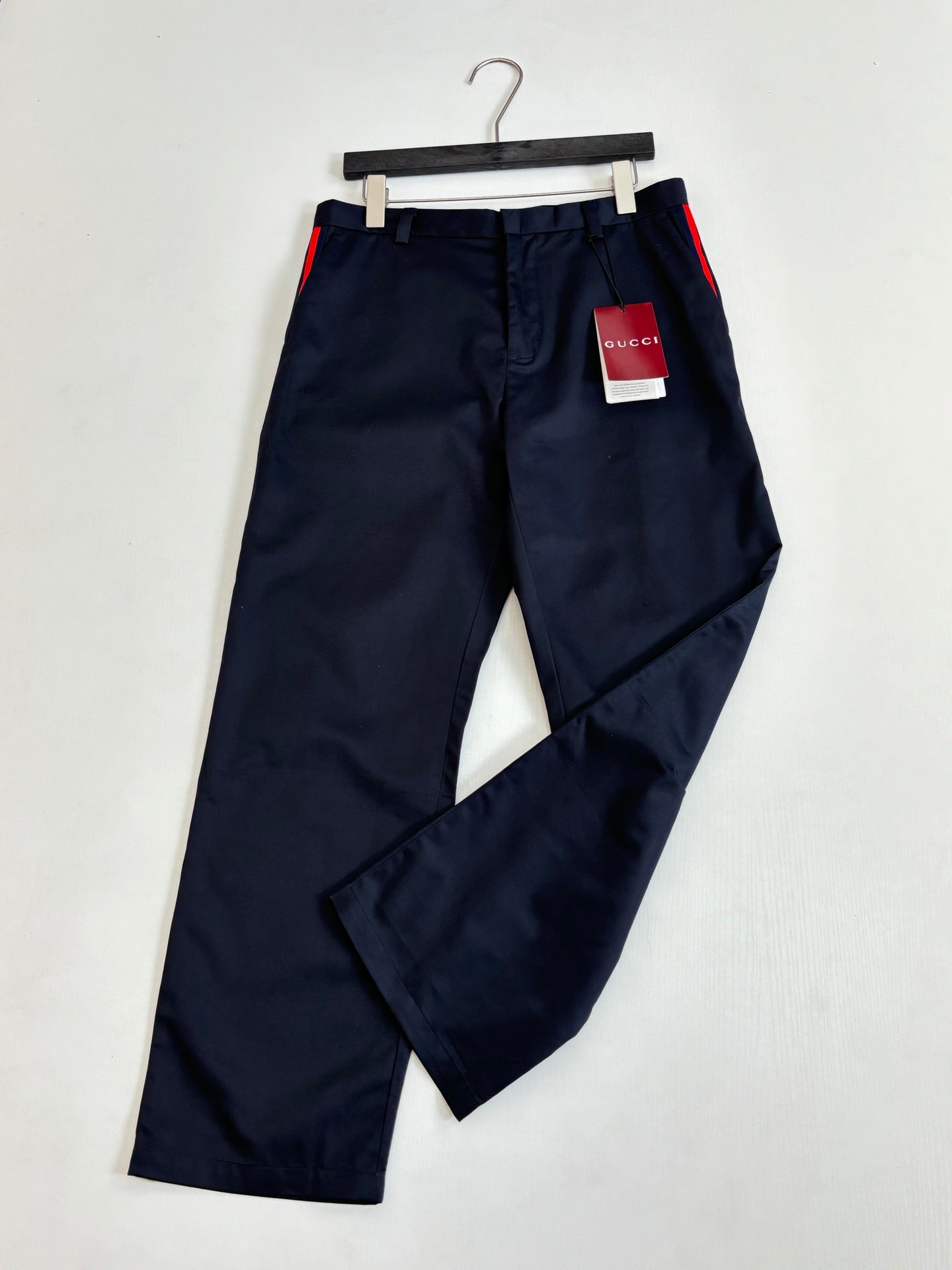 Gucci navy pants on hanger, front button closure with belt loops