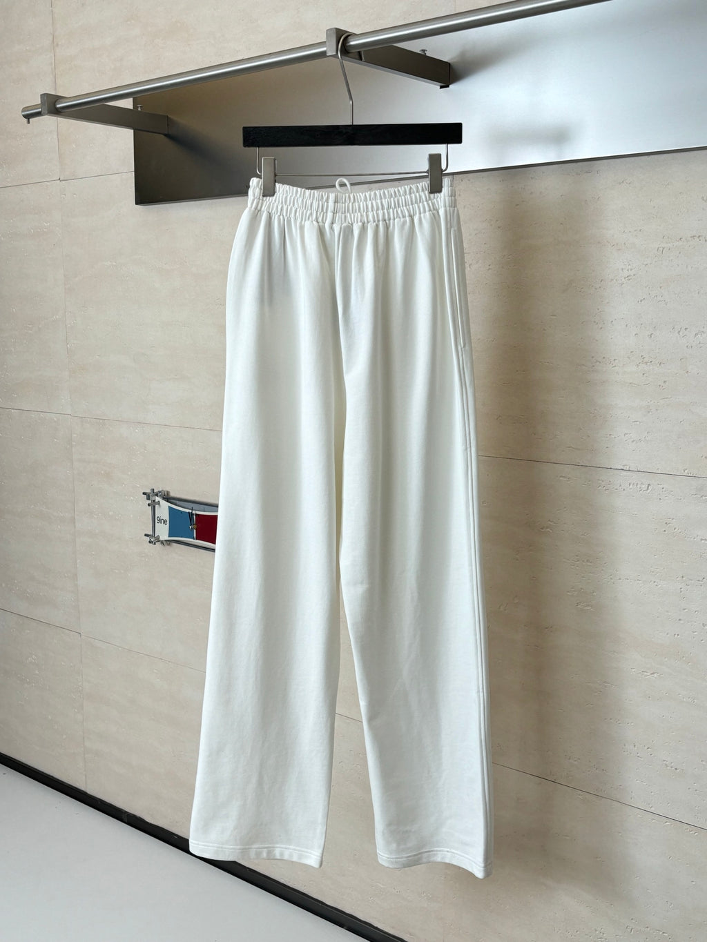 White wide-leg drawstring pants with elastic waist and straight hems