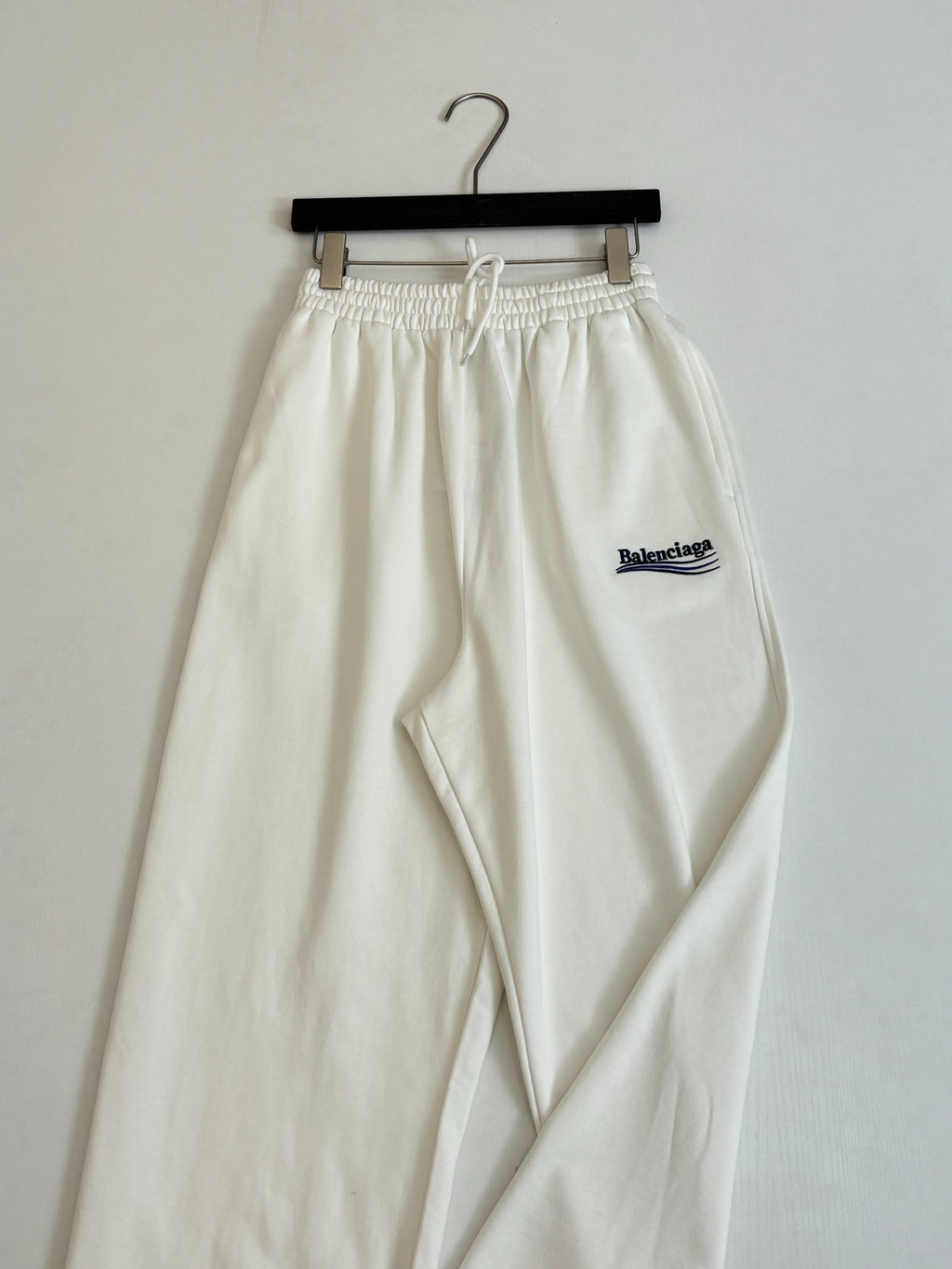 White drawstring pants with elastic waist and Balenciaga logo patch