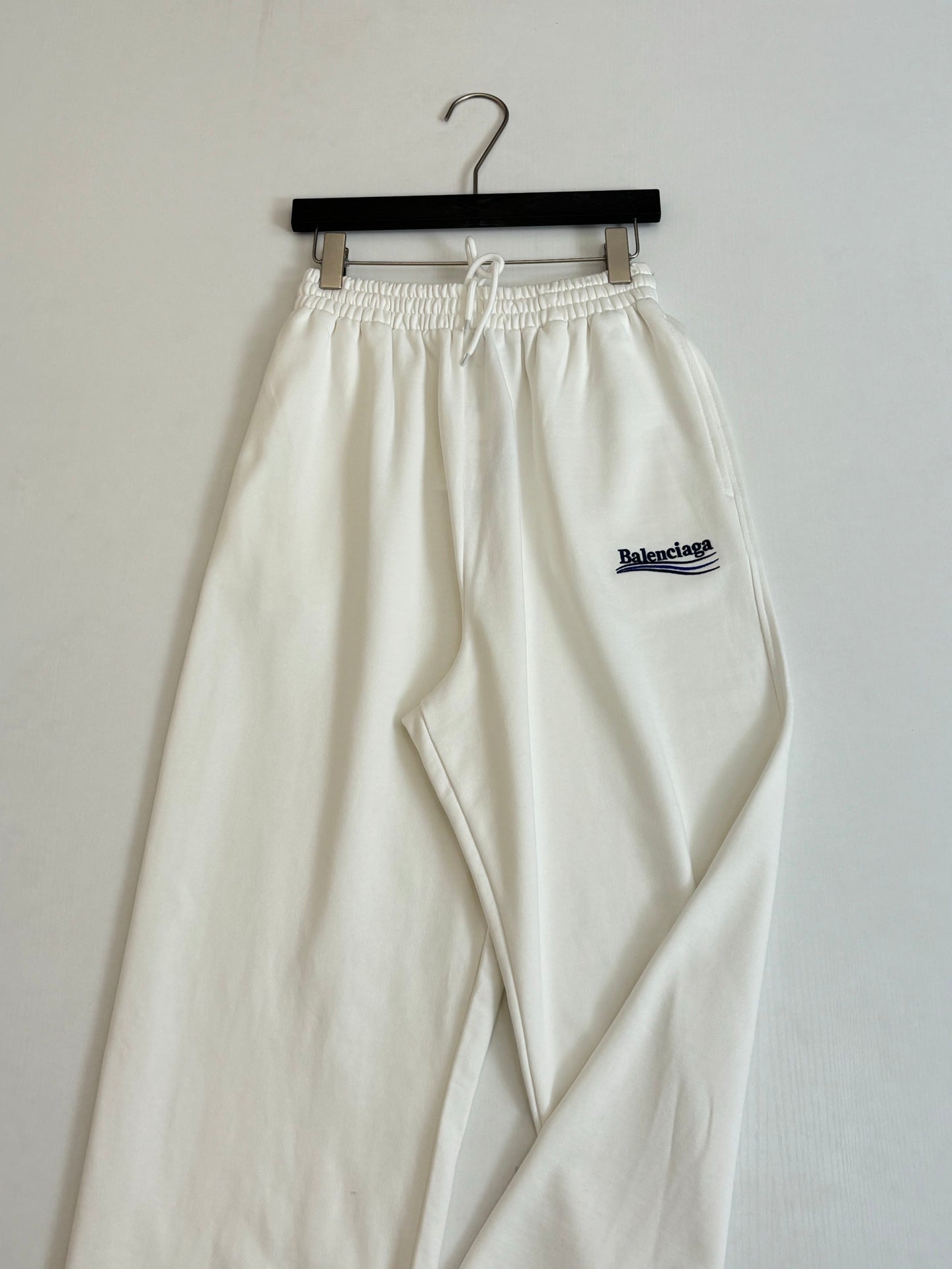 White drawstring pants with elastic waist and Balenciaga logo patch