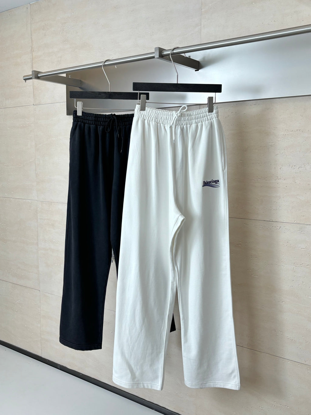 Pair of drawstring pants: black and white, both with elastic waistband