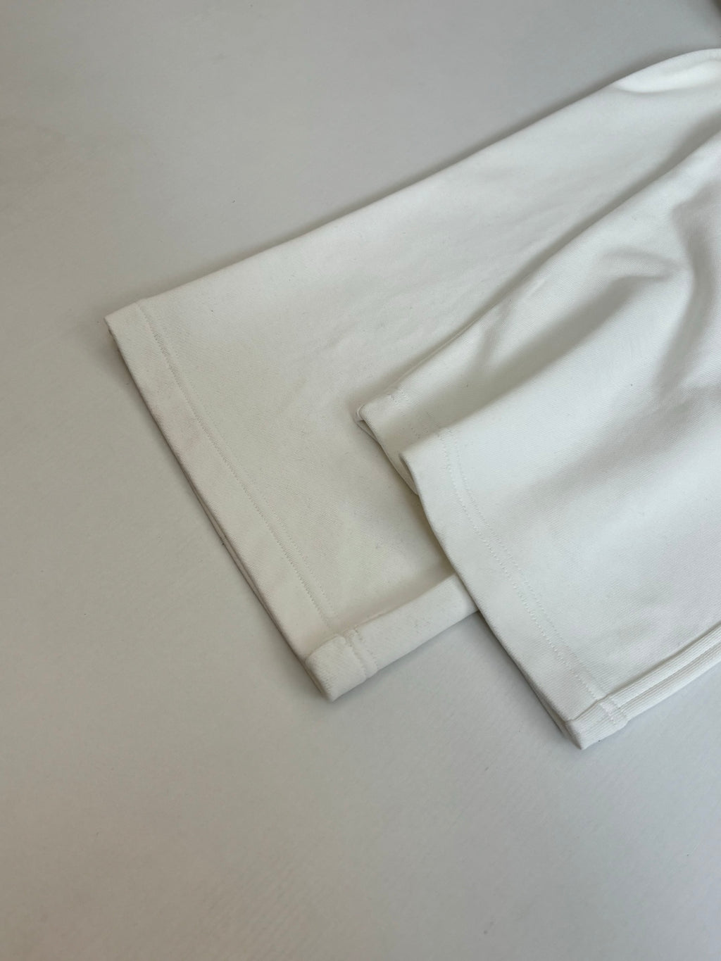 White wide-leg pants folded, with straight leg openings
