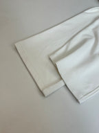 White wide-leg pants folded, with straight leg openings