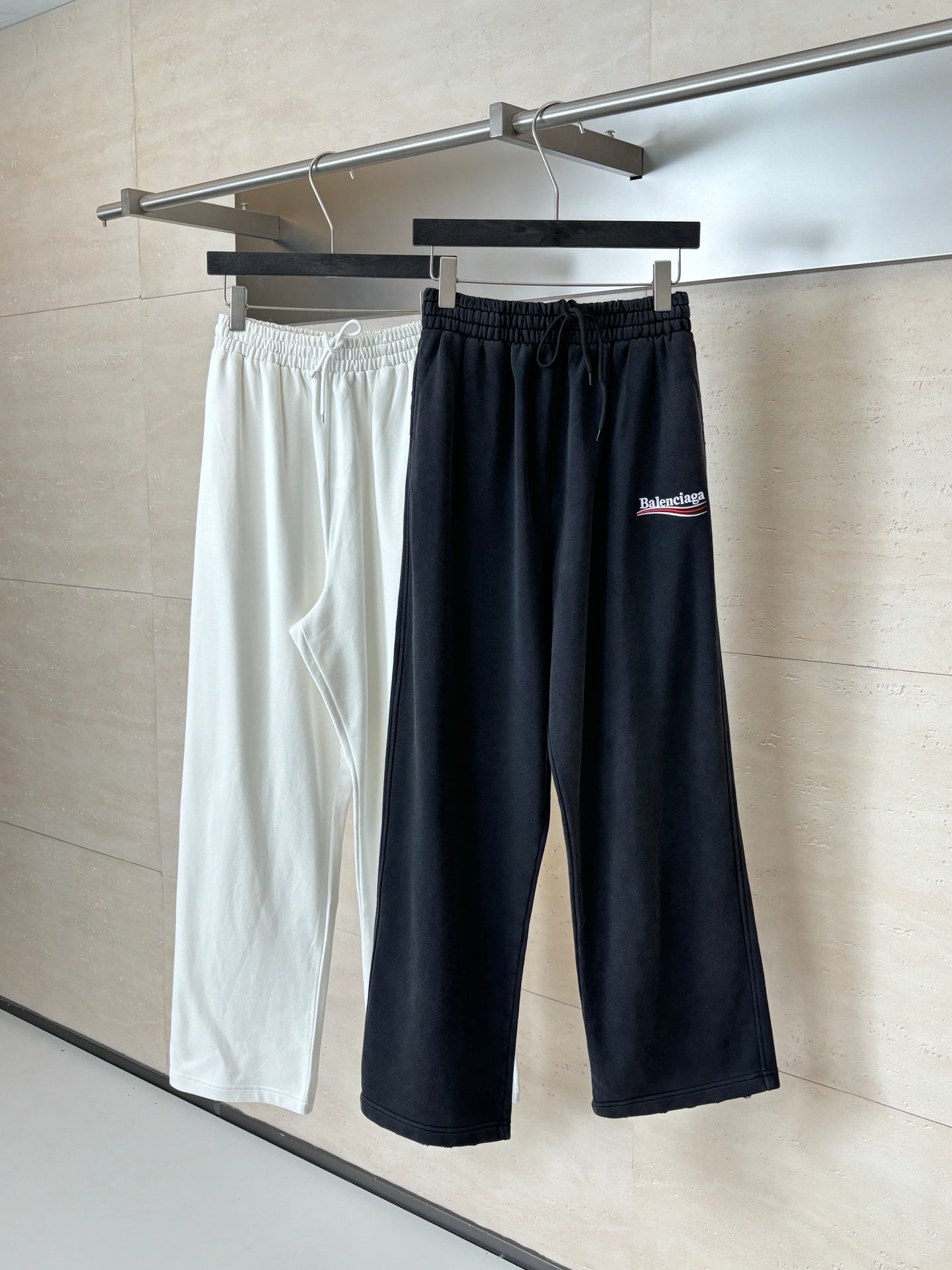 Pair of Balenciaga pants, one black and one white, elastic drawstring waistband