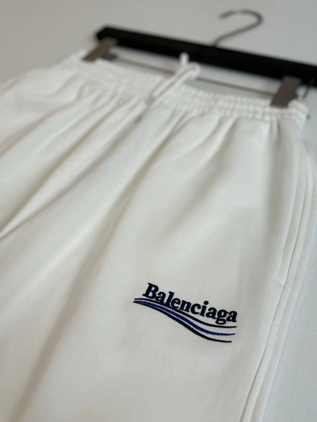 White drawstring pants with elastic waist and Balenciaga logo embroidery