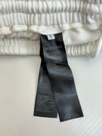 White pants size tag and care label on elastic waistband
