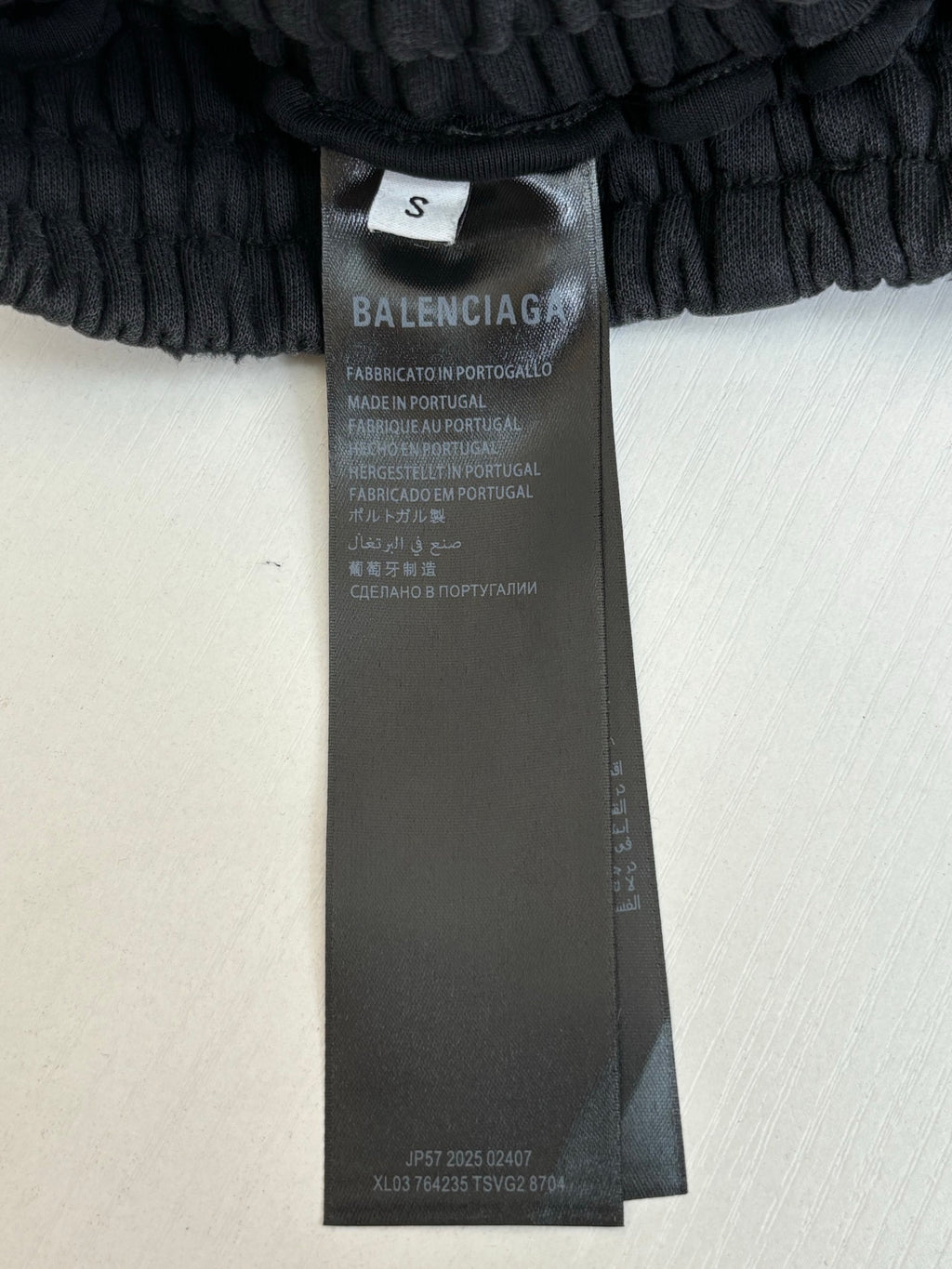 Balenciaga pants size and care tag on black fabric waistband
