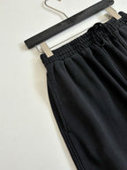 Black Balenciaga pants, close-up of elastic waistband and fabric texture